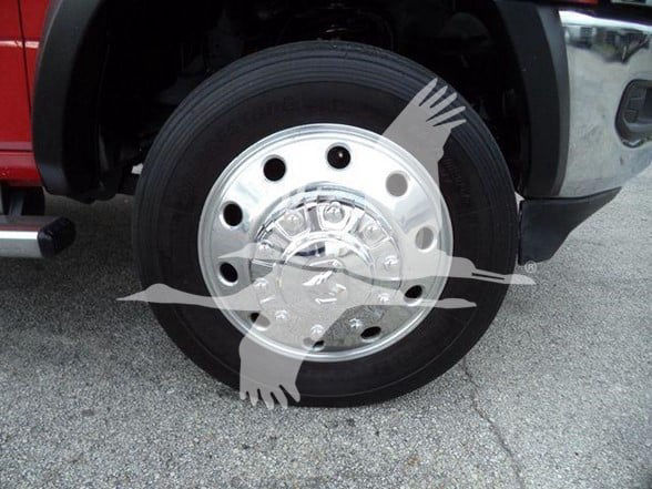Wheel with tire and chrome hubcap on a Ram 4500 tow truck. Partial truck body visible in background.