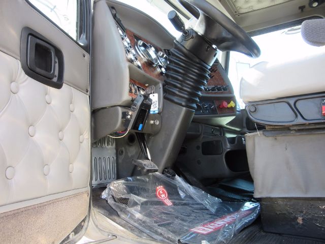 Kenworth T800 cabin interior with steering column, dashboard, and driver seat visible.