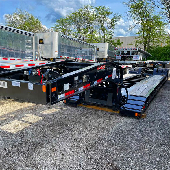 Magnum Fontaine MTG? Magnitude 60 MFLD lowboy trailer showing black steel frame, metal deck, side rails, and hydraulic components.
