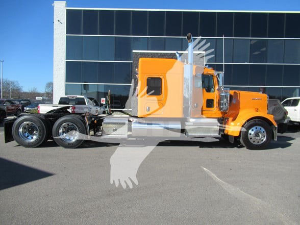 Kenworth W900L tractor in orange with chrome fenders and sleeper cab, side profile view.