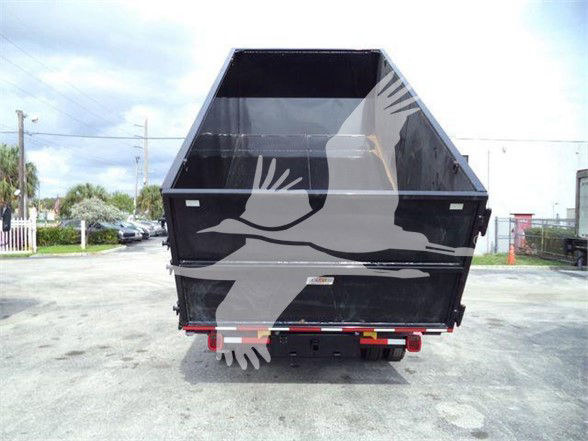 Dump bed view of a 2023 Chevrolet Silverado 6500HD dump truck showing rear with black bed sides and graphic wings overlaid.
