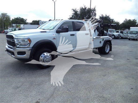 2024 Ram 5500 SLT tow truck with extended cab and front chrome grille, dual rear wheels on a flatbed.