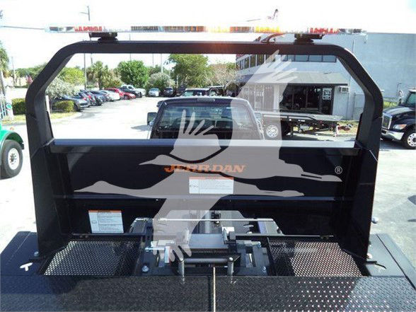 Truck bed with hydraulic hitch and framework. Visible text on side panel reads 'JOURNEY' or 'JURRAN'? and a silhouette graphic. No other legible technical labels visible.