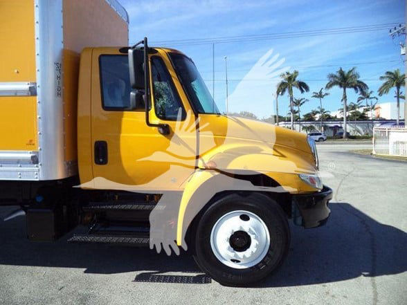 2019 International DURASTAR 4300 box truck in yellow with cab and front wheel visible.