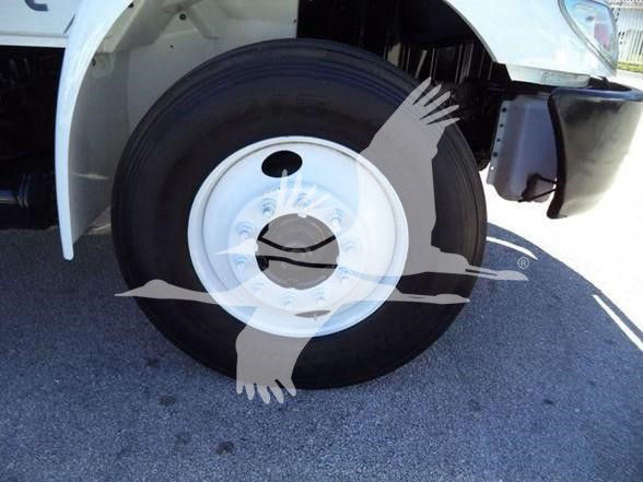 Front wheel and tire of a white 2019 International DURASTAR 4300 truck showing wheel and fender.