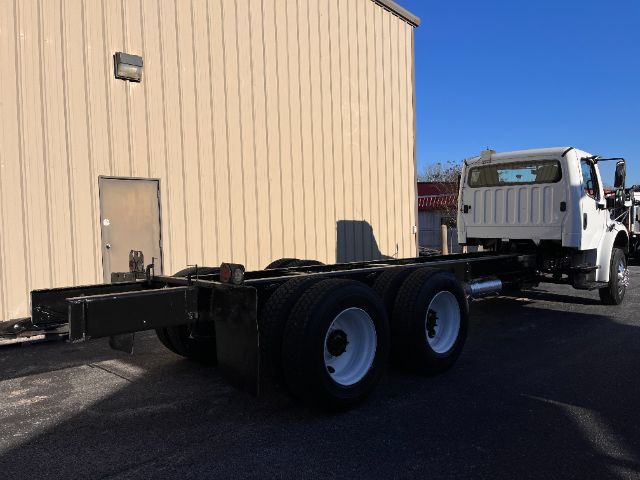 Truck chassis showing rear wheels and cab of a 2015 Freightliner M2 cab and chassis. No visible text on components.