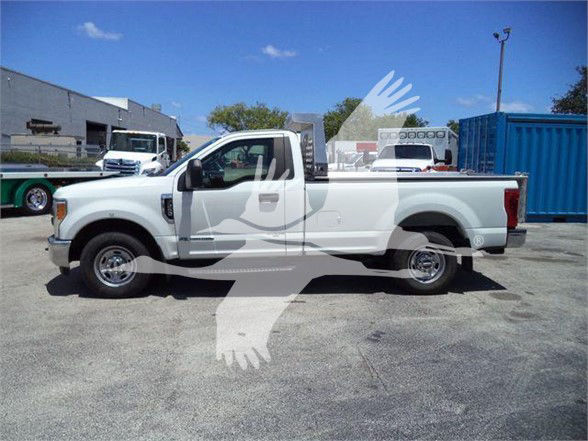 2017 Ford F250 pickup truck in a yard, white, single cab with a dump bed