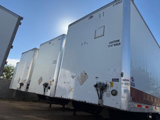 Utility 4000DX trailers in a row showing rear doors and safety decals