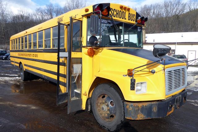 School bus in yellow with black trim, front grille, and open door showing bus side text. Freightliner FS65 model, VIN 4UZAAXBW82CJ57669.