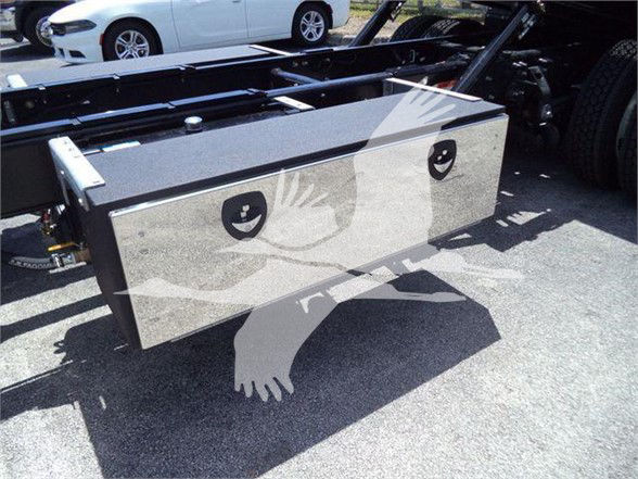 Boxed aluminum utility toolbox mounted on a truck chassis, with circular recessed handles and a glossy finish.
