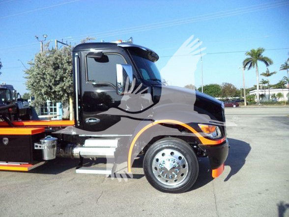 Kenworth T280 tow truck side view showing black cab, chrome steps, front wheel, and orange graphics.