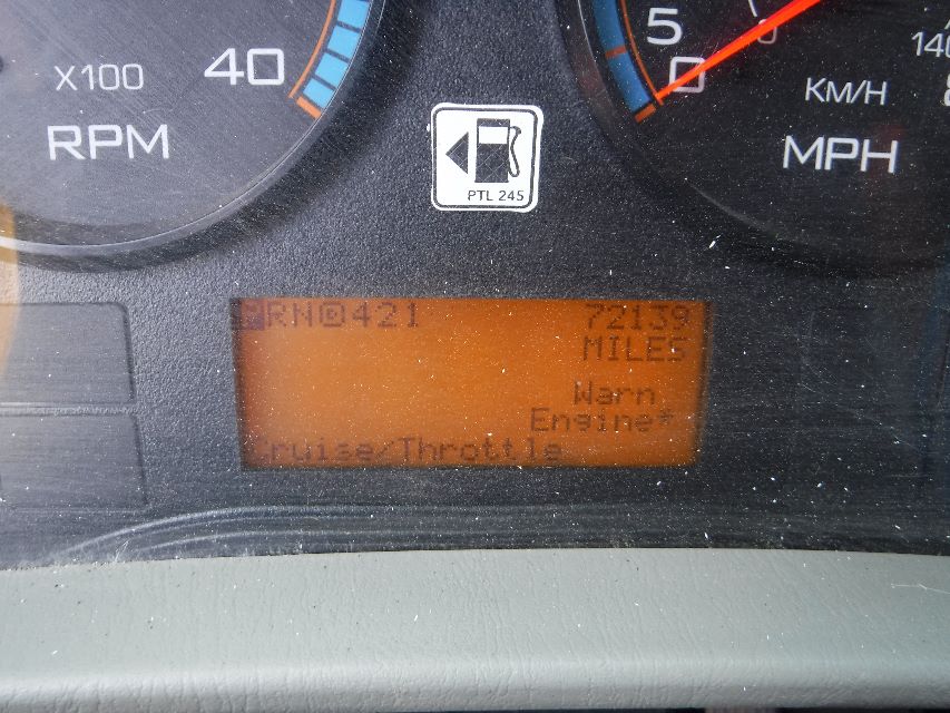 Dashboard display showing digital odometer and gauge cluster from a 2018 International 4300 with orange backlit LCD. Visible text includes engine data and mph gauge.