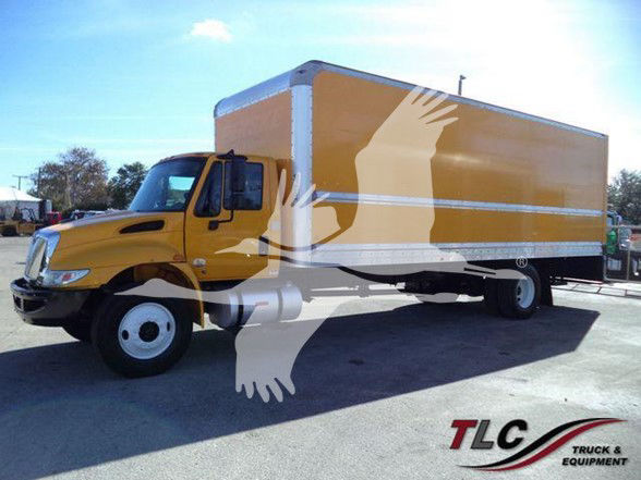 Box truck with yellow cab and large yellow box. TLC Truck & Equipment logo bottom right. No legible text on vehicle besides TLC watermark.