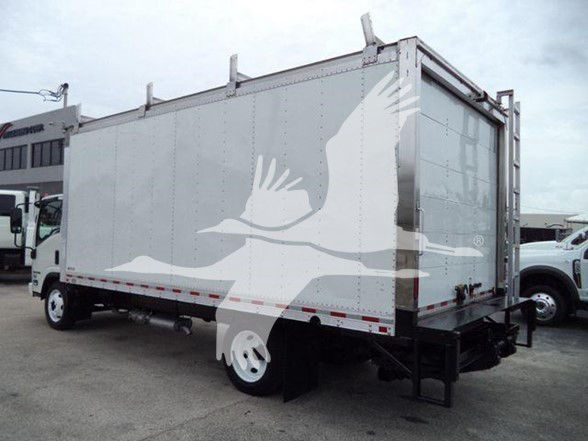 Box truck in a lot showing a large enclosed cargo area on a Isuzu NPR HD; no legible labels visible on the side; generic trailer with white and gray color.