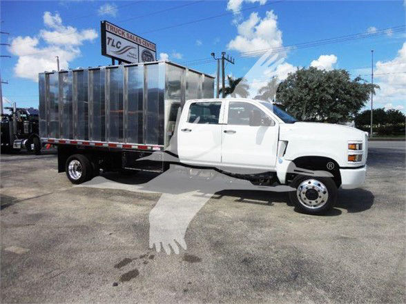 Truck: 2023 International CV dump truck with a silver cargo bed, white cab, and dual rear wheels.