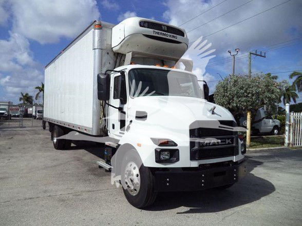 Rear-view of 2023 MD6 refrigerated truck with Thermo King unit on top, white cab, long white trailer, side mirrors, and black front bumper.