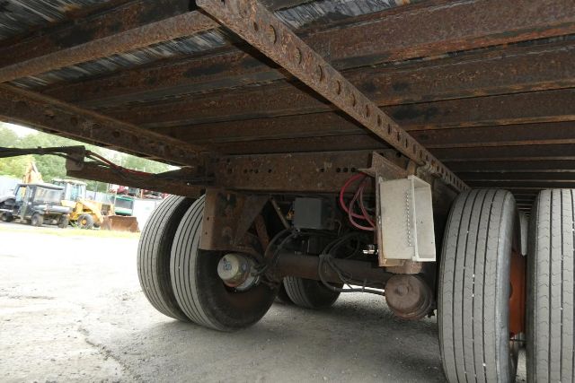 Great Dane 7311TP-SAR trailer undercarriage showing dual rear axles and rusty frame with electrical box and red wiring.