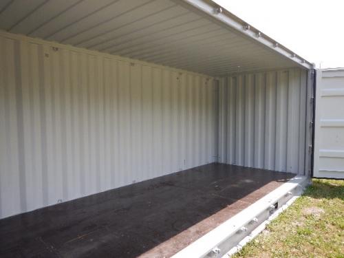 20' open side shipping container interior showing metal walls and wooden floor