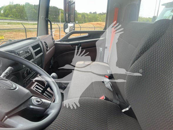 Cab and Chassis interior of a 2026 Hino L6 showing steering wheel, driver and passenger seats, dashboard, and sun visor.