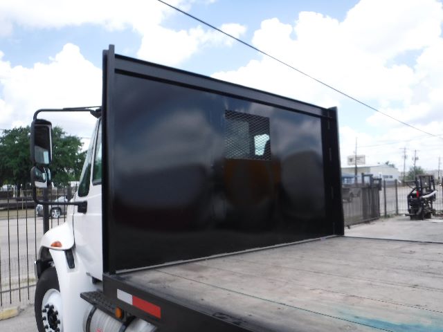 2018 International 4300 flatbed truck with dump-style black divider panel in truck bed.