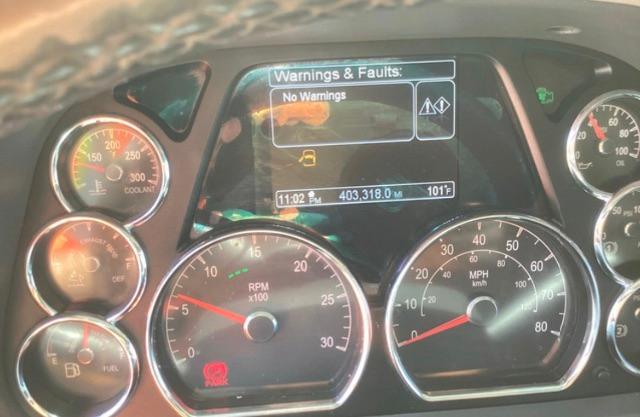 Peterbilt truck instrument cluster with digital display showing 'Warnings & Faults: No Warnings' and odometer 403,318.0 miles; RPM gauge; speedometer; fuel gauge; temperature gauge.