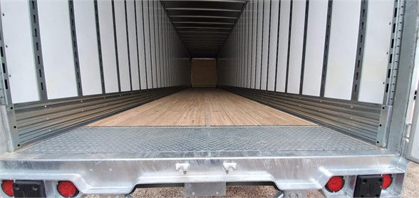 Vanguard MAXCUBE dry van trailer interior showing wood floor and metal sidewalls with loading doorway.