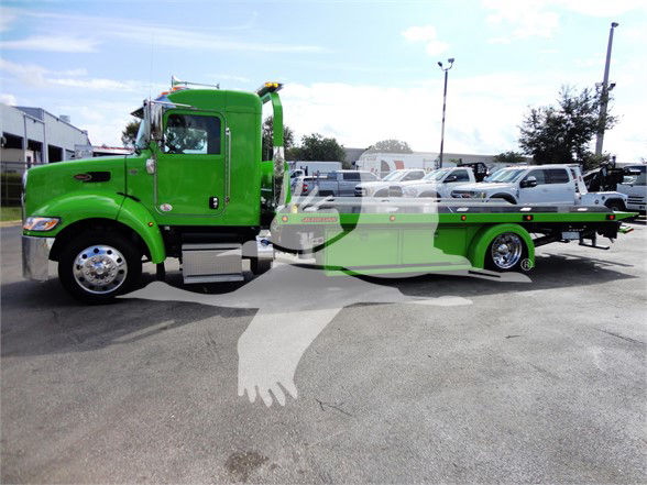 Green 2022 Peterbilt 337 tow truck shown in side profile, with flatbed. Stock number J47210 visible in lot.