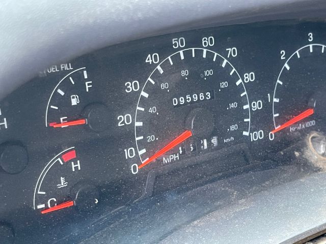 Ford F-450 dashboard showing speedometer up to 100 mph, odometer reading 095963, fuel gauge near full, coolant temperature gauge, and tachometer with redline around 4000 RPM.