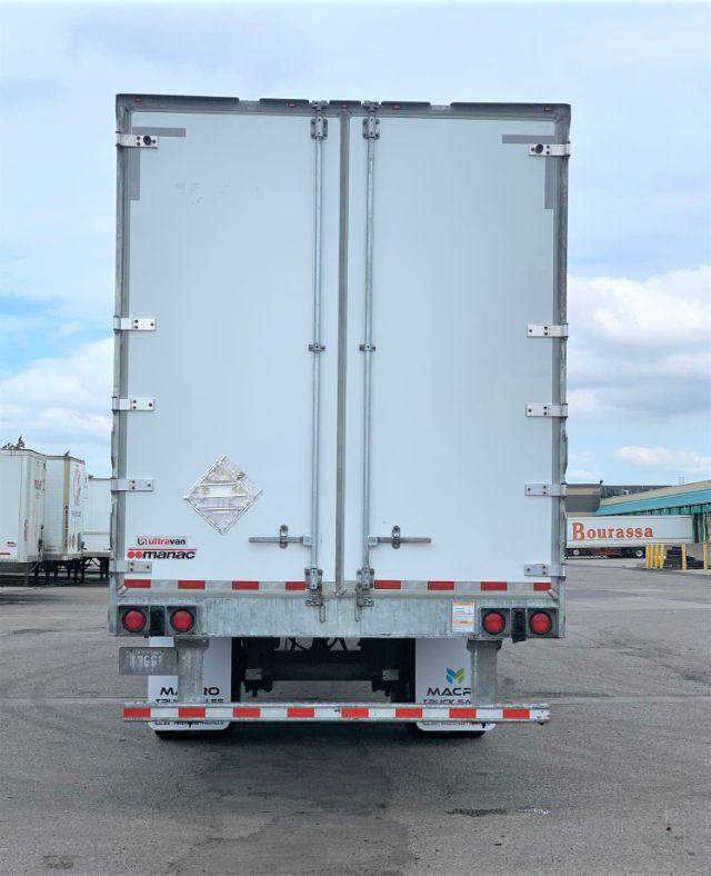 Manac dry van trailer back view showing double rear doors and reflective tape, Ultraspan Manac logo, and taillights.