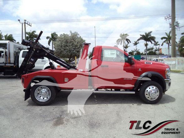 2024 Ram 4500 SLT tow truck side view showing red cab and black equipment, TLC Truck & Equipment watermark.