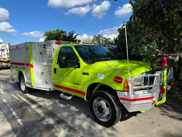 2001 Ford F550 fire truck in lime green color with red and white stripes parked outdoors.