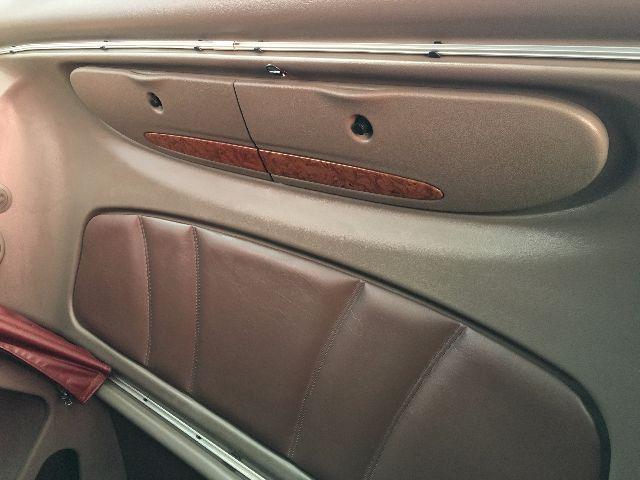 Peterbilt 578 interior door panel and seating area showing tan upholstery and wood grain trim.