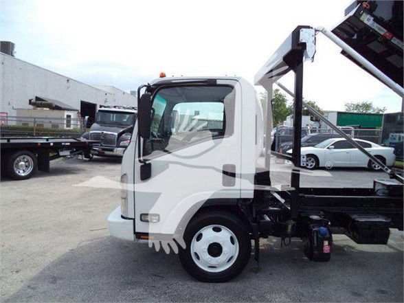 Isuzu NRR truck cab side view with white body and black chassis, part of a refuse truck setup.