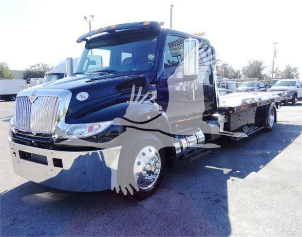 2022 International MV tow truck front-left side view showing flatbed and chrome grille.