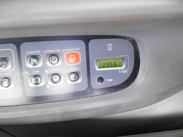 Control panel with various labeled buttons and a digital trip meter showing '3956' in a green display.