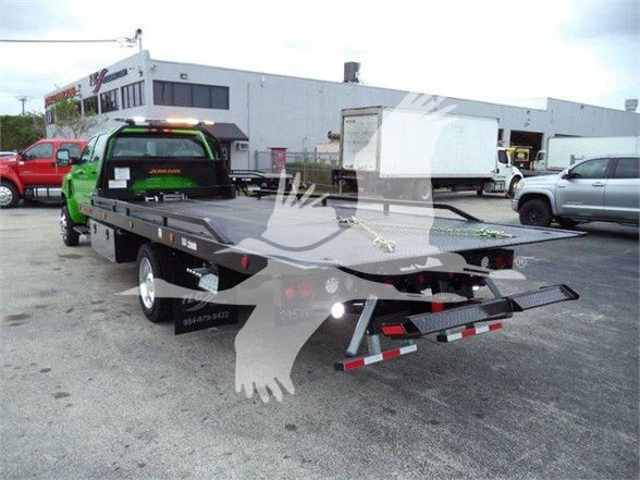 2023 International CV tow truck rear view with flatbed and branding. Visible text includes VIN/stock on the listing context but not clearly on the vehicle.