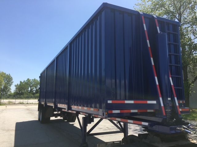 Blue 2006 utility 40 ft square dump trailer showing side panels and rear gates with reflective safety stripes.
