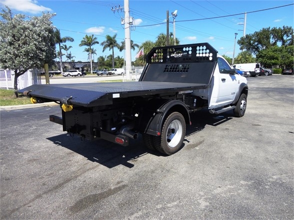 Ram 5500 HD hooklift truck flatbed rear view showing heavy-duty platform and rear bumper setup.