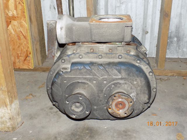 Paragon P857 blower and PTO unit with belt-driven pulleys and housing, viewed front-on in a storage area.