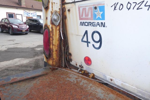 Morgan brand rear of Freightliner M2 106 box truck with rusted rear door and number 49, VIN 1FVACWCS34HM79876 visible.