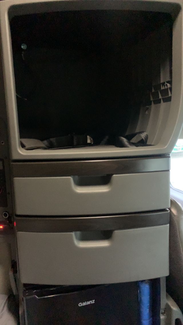 Cabin interior of a 2019 Volvo VNL64T860 showing a stacked storage cabinet with two drawers and a Galanz appliance at the bottom.