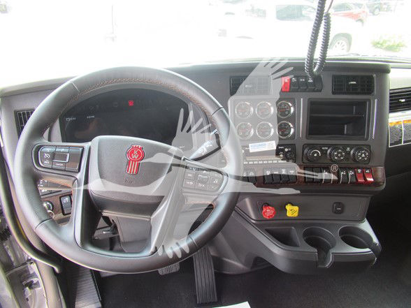 Kenworth W990 dashboard showing steering wheel, instrument cluster, center console, and control panel.