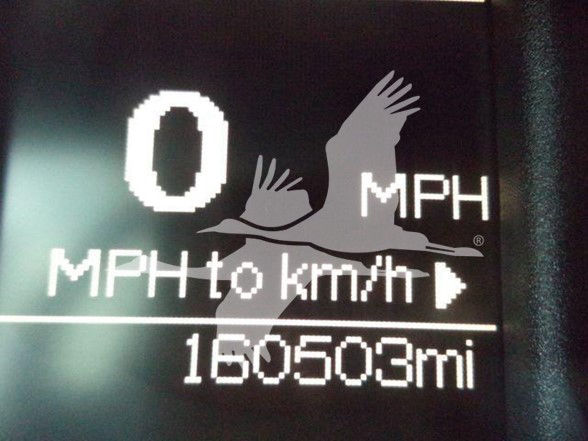 Vehicle dashboard display showing 0 MPH, 'MPH to km/h' indicator, and a odometer reading of 160503 miles.