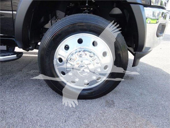 Wheel and tire of a Ram 5500 truck showing steel front wheel with multiple circular holes and center cap.