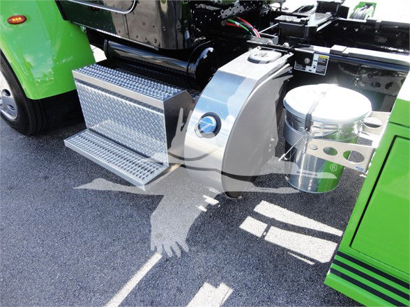 Truck side-step area with chrome toolbox and fuel tank visible on a green Peterbilt 337.